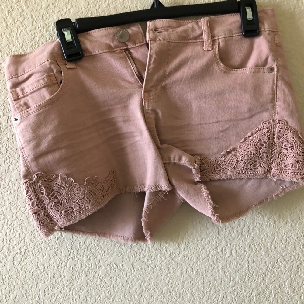 Pink jean shorts with floral bottoms